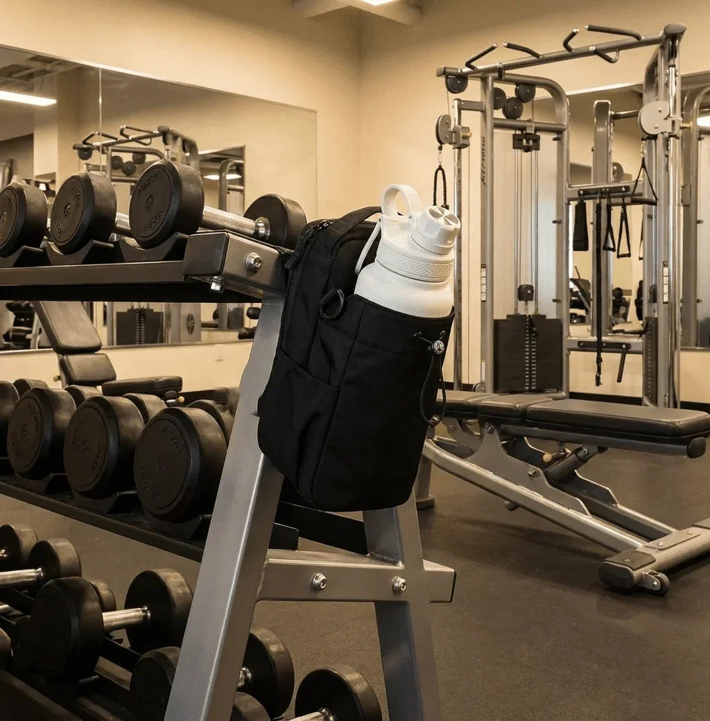 Magnetic Gym Bag with water bottle attached to weight rack in clean fitness gym, GlenNest