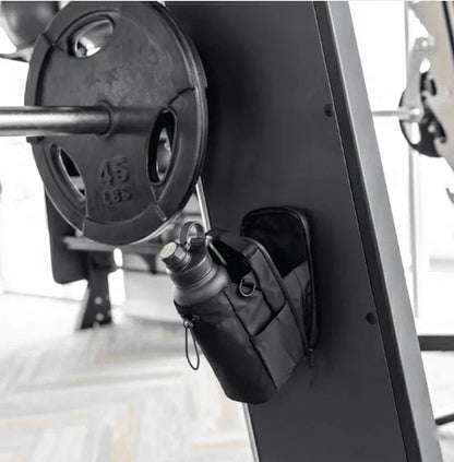 Magnetic Gym Bag from GlenNest holding a water bottle, attached to gym equipment
